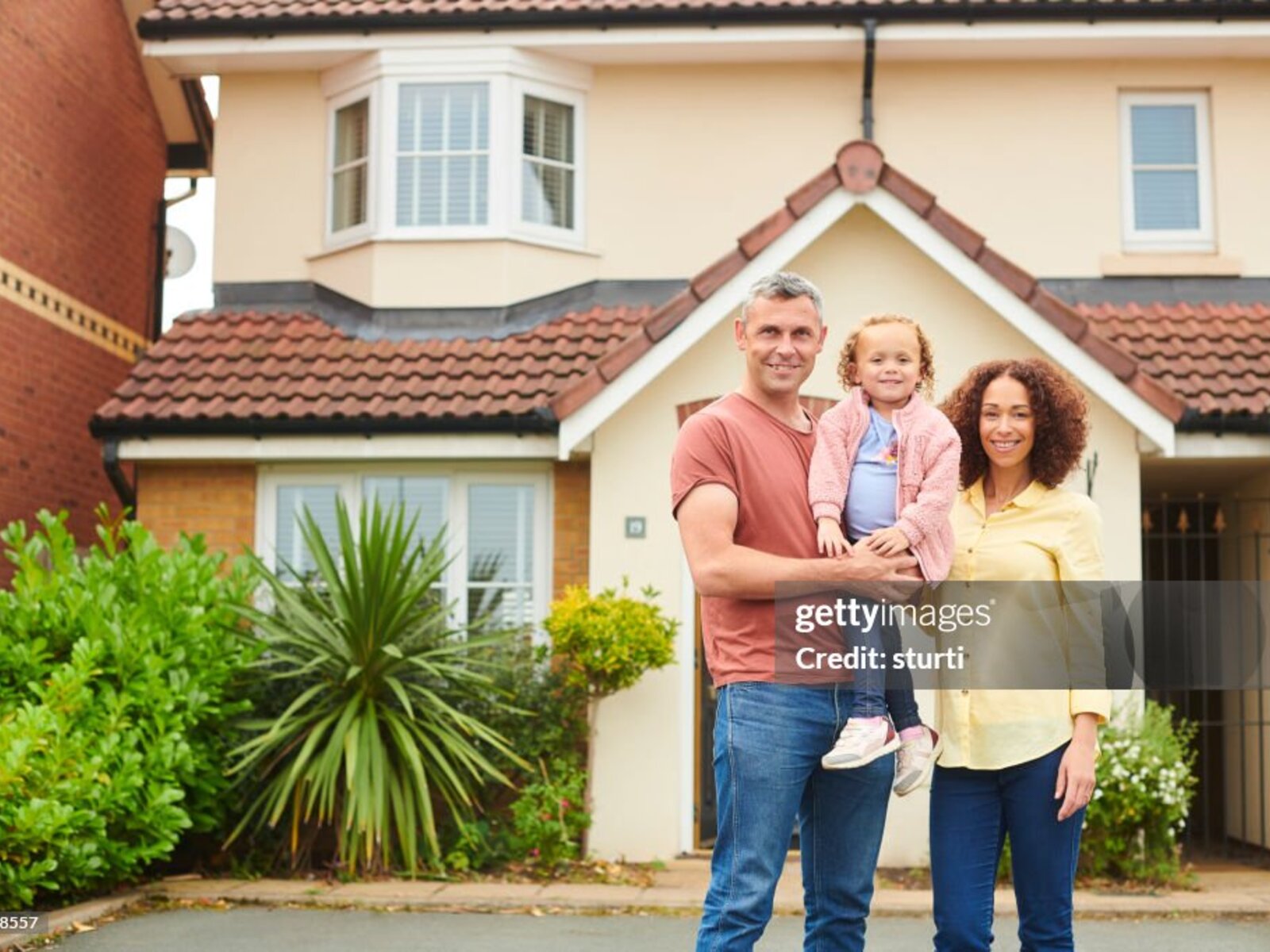 Happy UK homeowner with completed roofing project